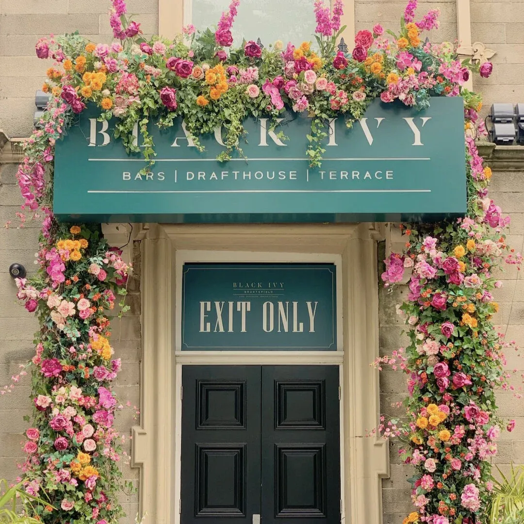 Flowers framing the Black Ivy entrance