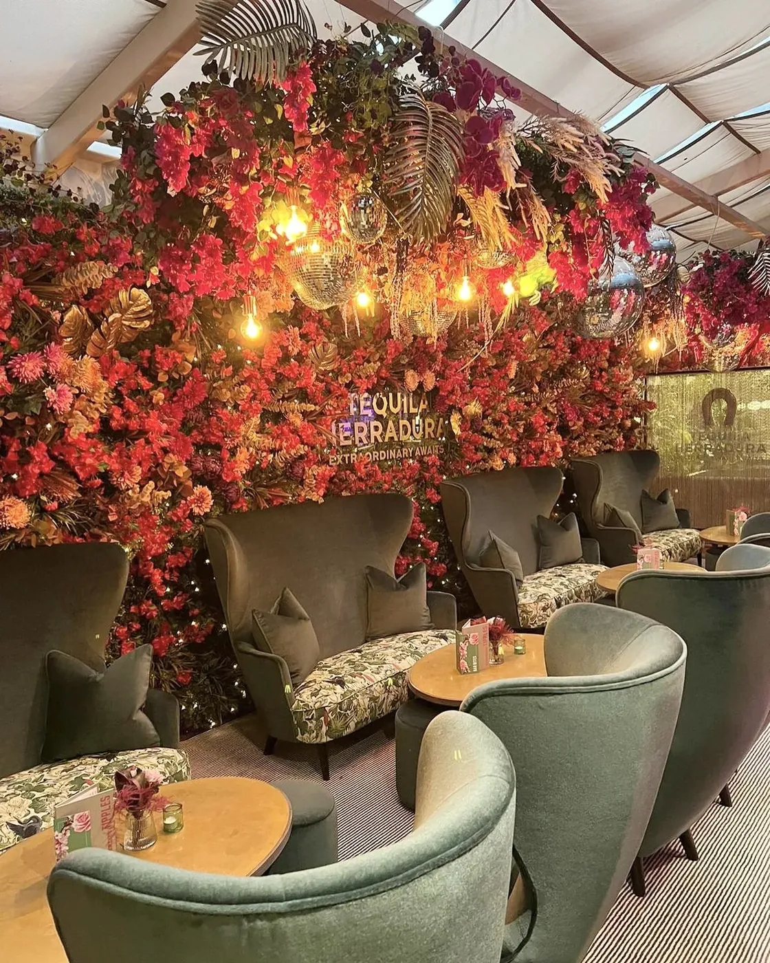 A lounge under a ceiling of red and orange flowers