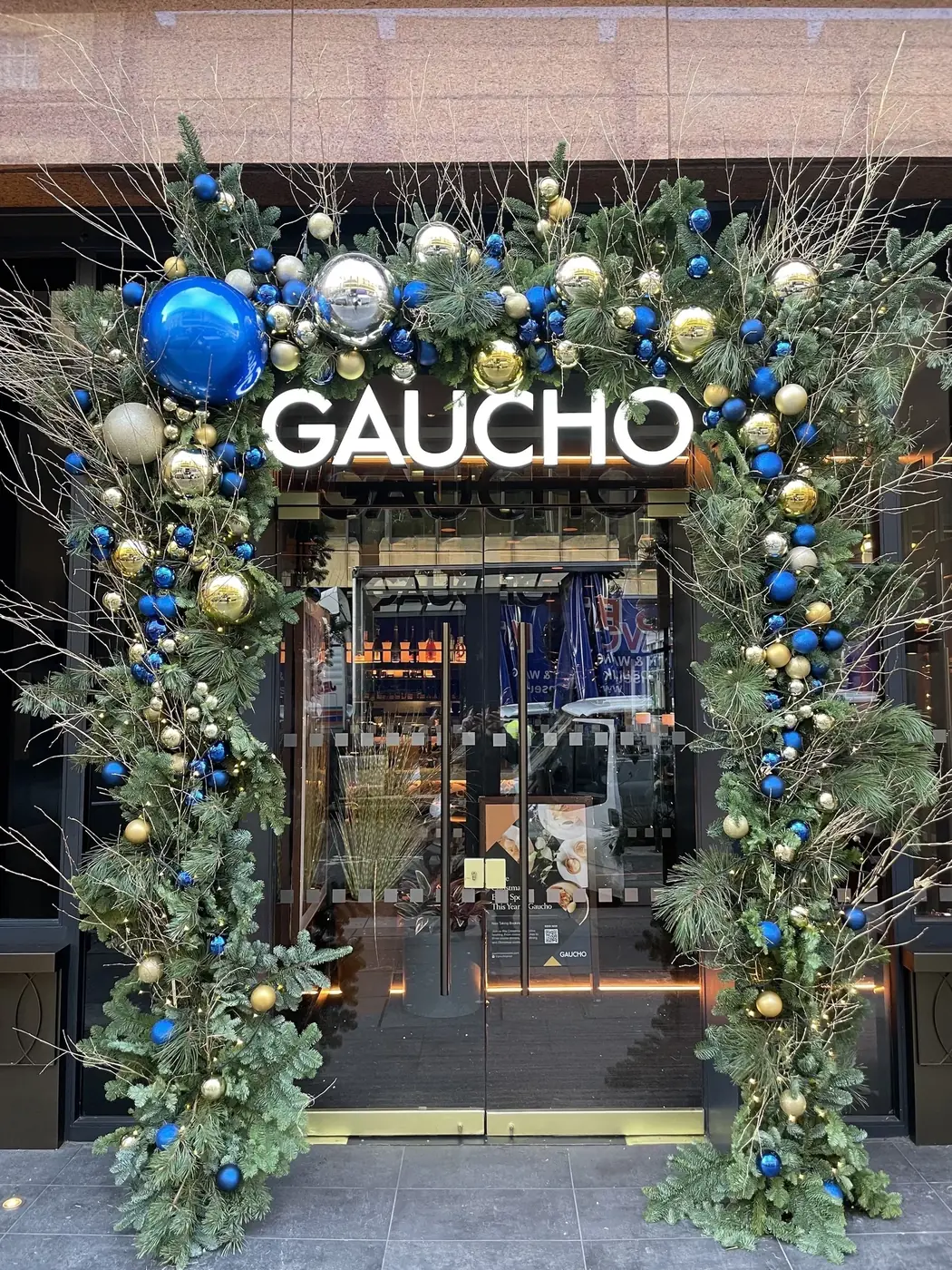 Blue, gold and green baubles framing the entrance to Gaucho