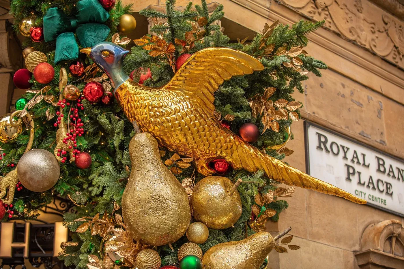 Golden pears and a gilded bird among baubles and garland
