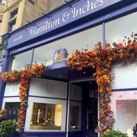 Copper and orange autumn leaves over the Hamilton & Inches windows