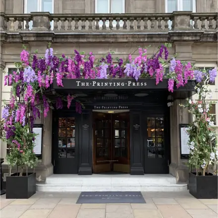 Wisteria cascading over the entrance to The Printing Press