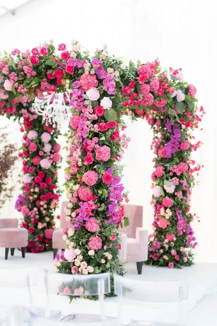A pink and red rose arch at a Gleneagles wedding