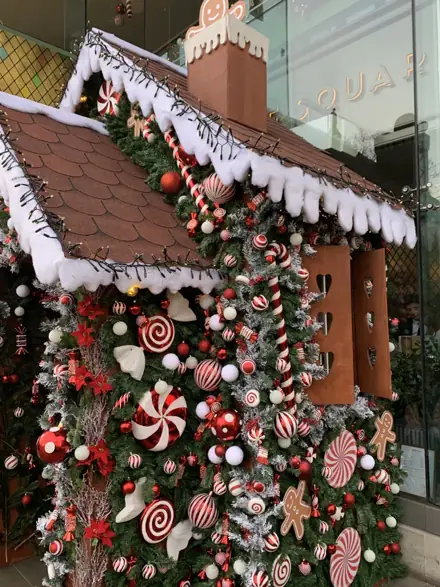 A gingerbread-house entrance with candy canes and peppermints